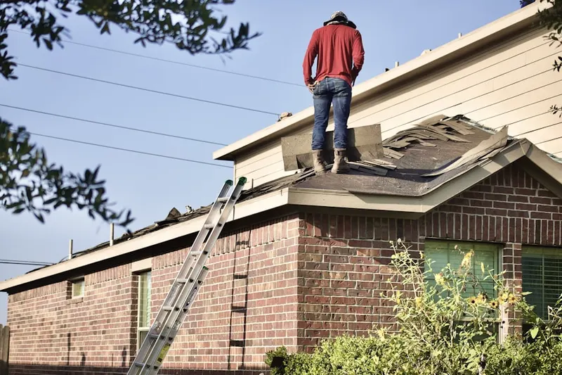 Professional roofer working on a residential roof in Rolling Hills Golf and Tennis Club